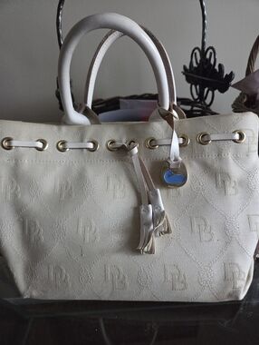 Dooney & Bourke Cream Tote Bag with Gold Hardware Charm & Tassel Excellent